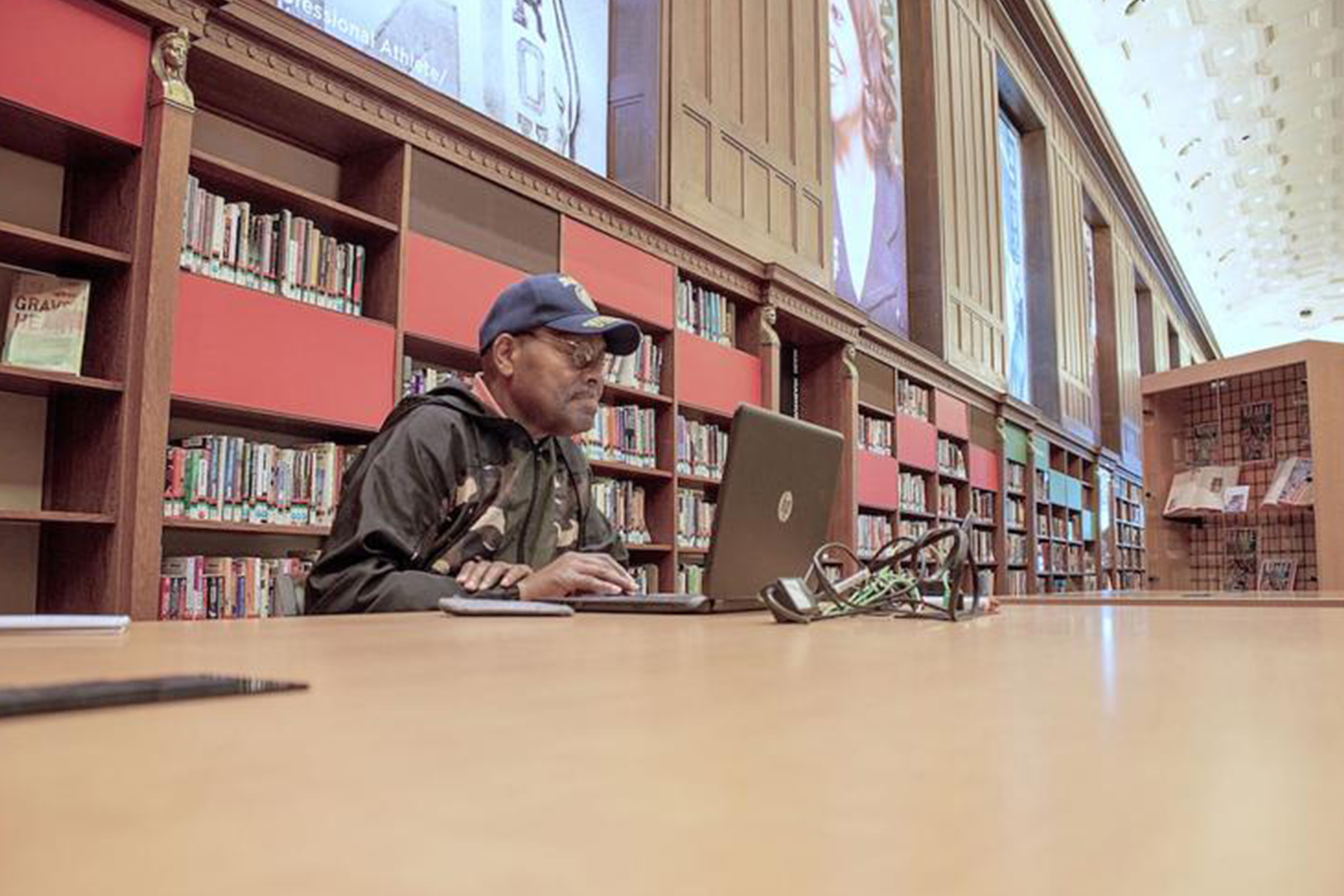 Earl Smith, 67, visits the library three or four times a week to do research and enjoys browsing through the collection at the Center for Black Literature and Culture. (Photo by: Tyler Fenwick)