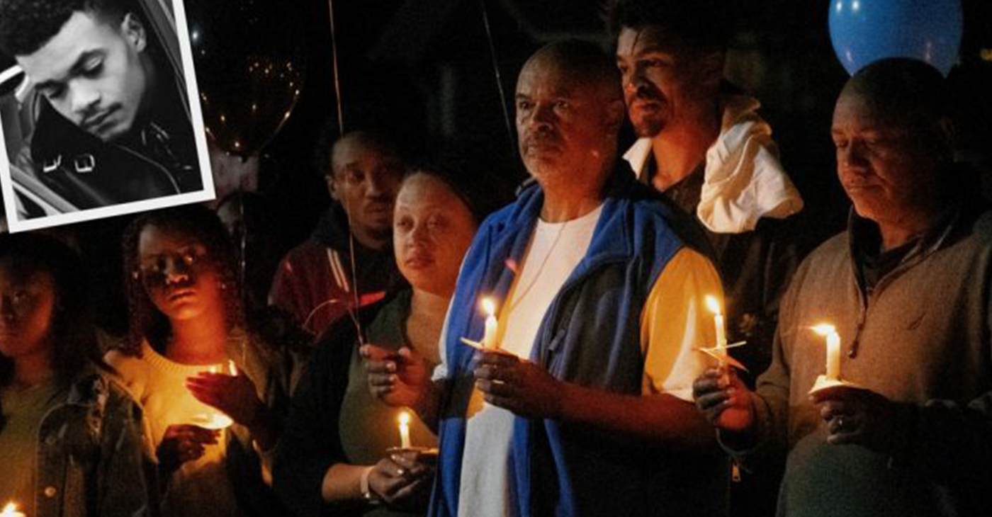 During a candlelight vigil on Oct. 6, Phillip Brooks Sr. is joined by son Phillip Brooks Jr. and daughter Markia Abdur Rahama as they remember their loved one, Bryant Brooks (inset photo), who was murdered in Oxon Hill on Sept. 30. (Photo by: Charles Nyonga)