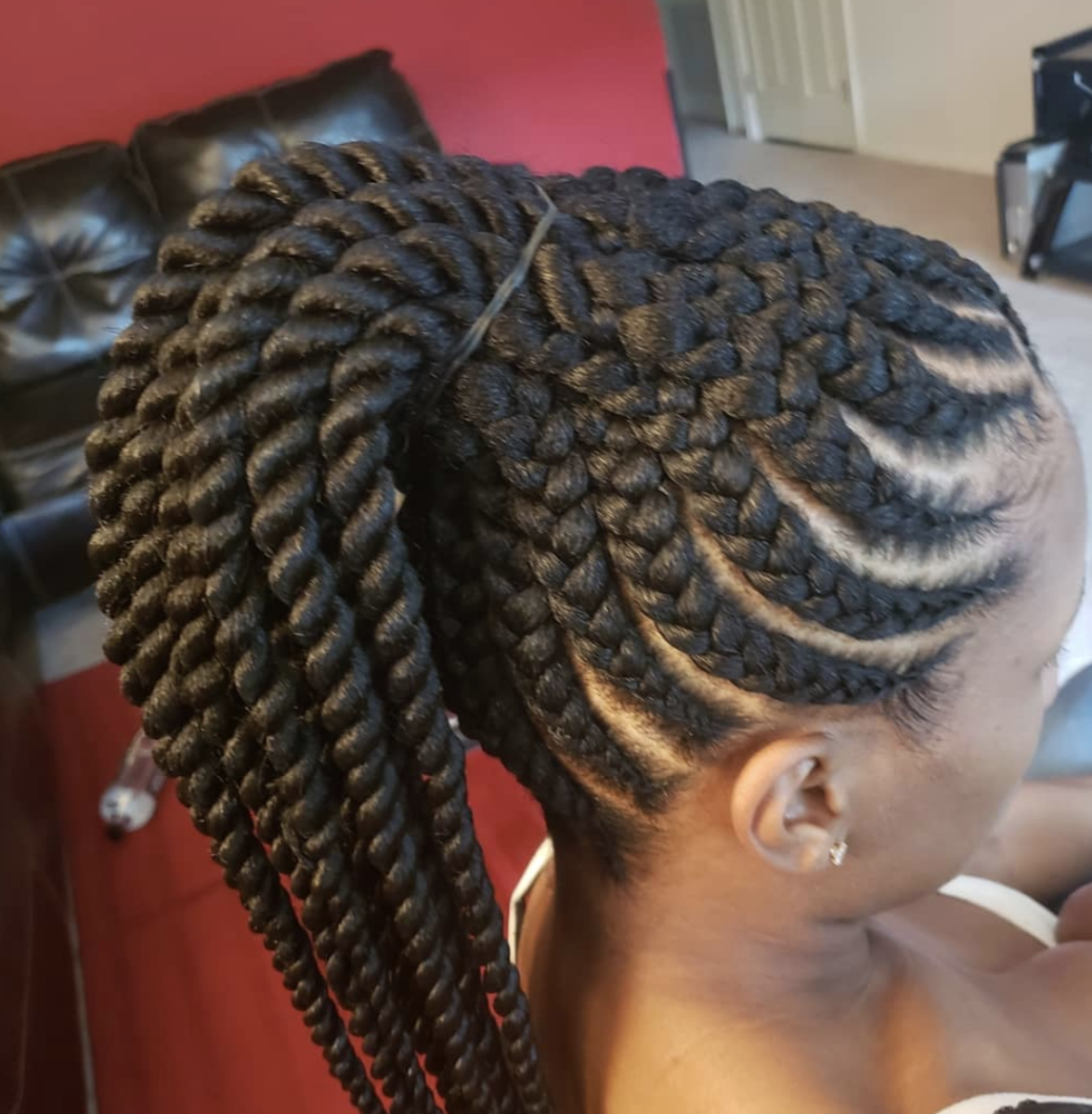 woman with braids sits in salon chair