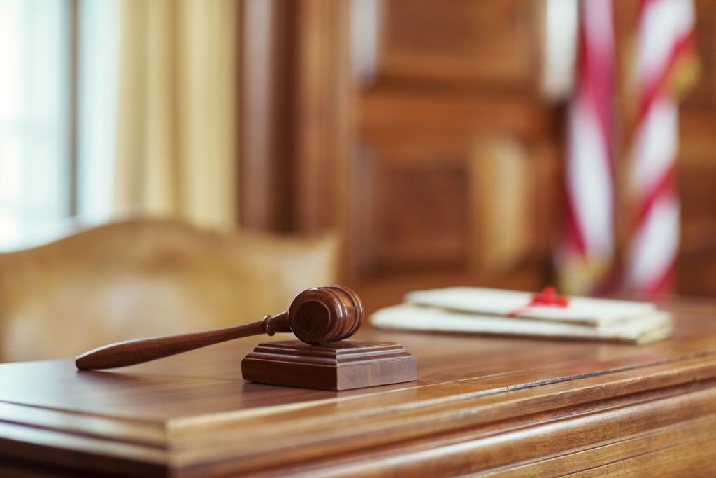 Gavel laying on judges bench in courtroom