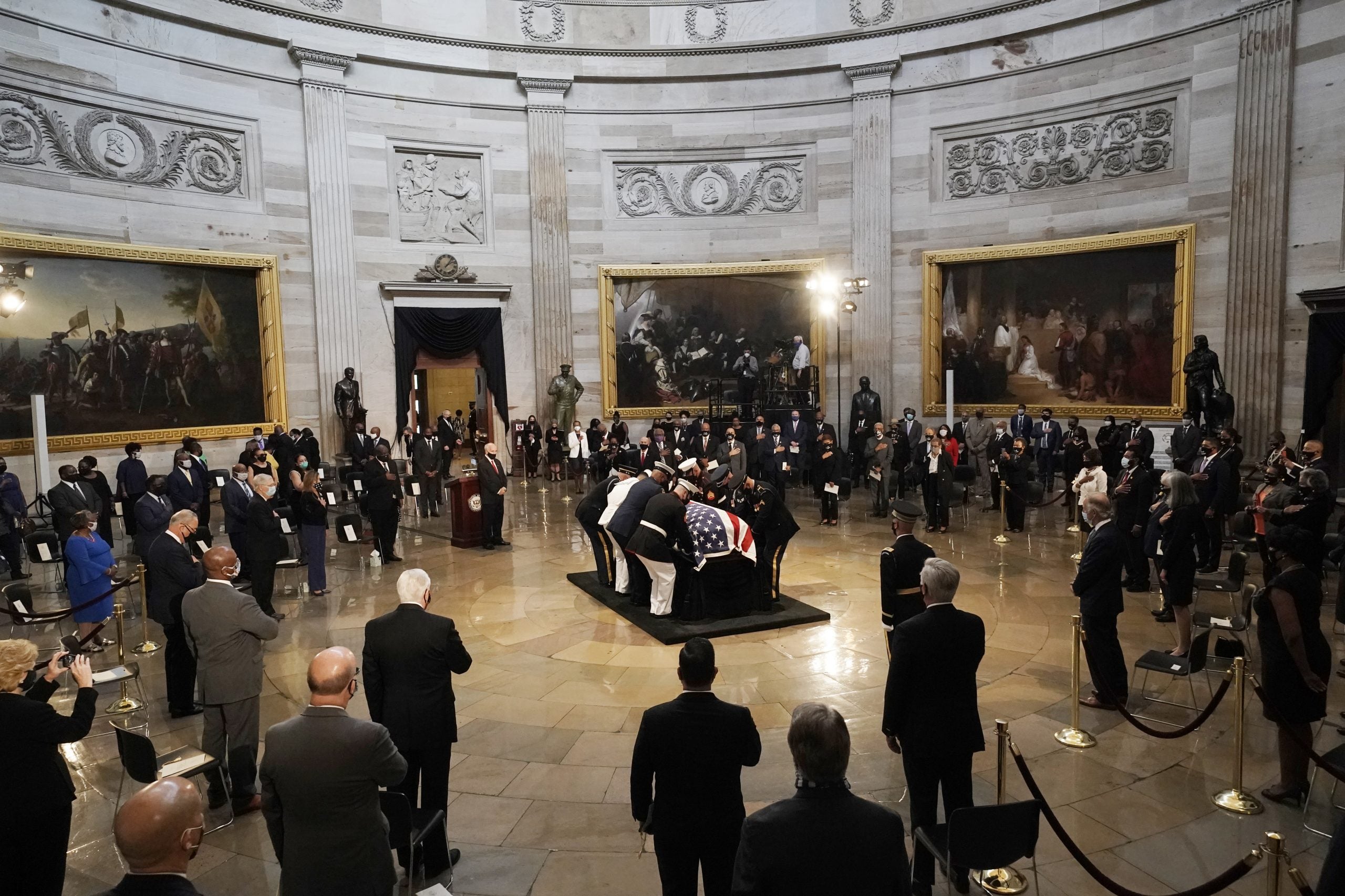 WASHINGTON, DC - JULY 27: The flag-draped casket of the late Rep. John Lewis (D-GA) is placed on the catafalque by a joint services military honor guard where it will lie is state in the Capitol Rotunda on July 27, 2020 in Washington, DC. Lewis, a civil rights icon and fierce advocate of voting rights for African Americans, will lie in state at the Capitol. Lewis died on July 17 at the age of 80. (Photo by J. Scott Applewhite - Pool/Getty Images)