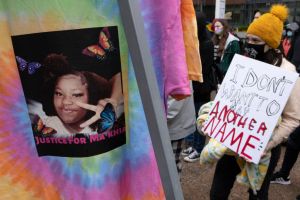 Black Lives Matter activist holds a placard during the Ma...