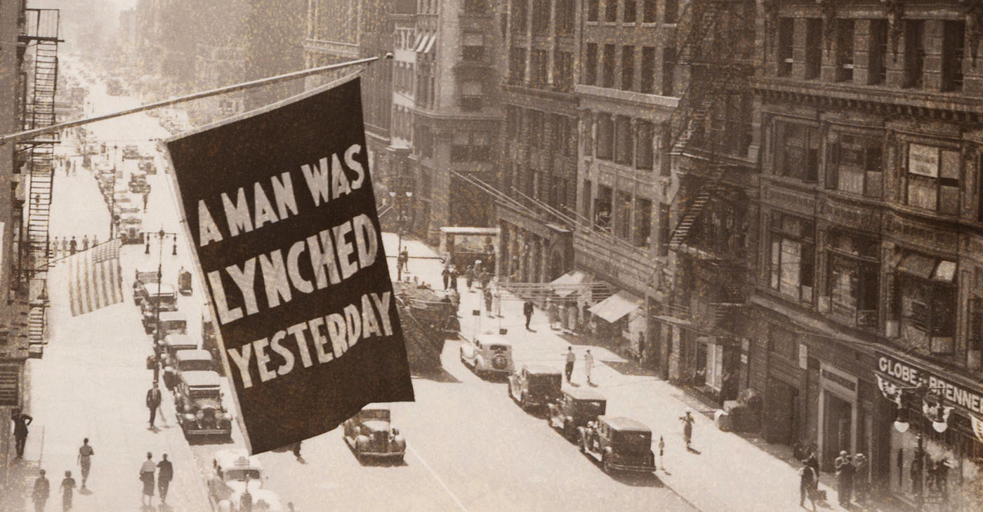 The series showcases compelling narratives of those impacted by newspaper accounts, including the 1908 case of Annie Walker, who begged “night riders” for mercy before she was killed, according to a report in the Public Ledger newspaper in Kentucky. (Photo: Flag announcing another lynching. 