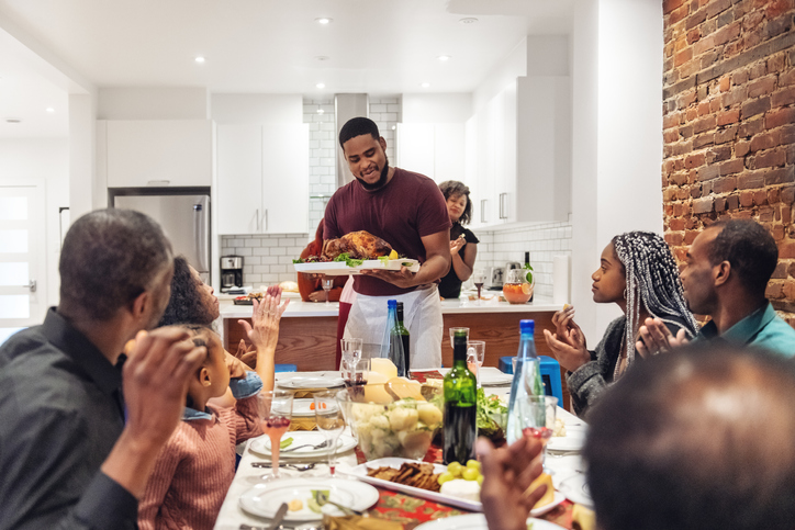 Multi-generation ethnic family having Thanksgiving dinner