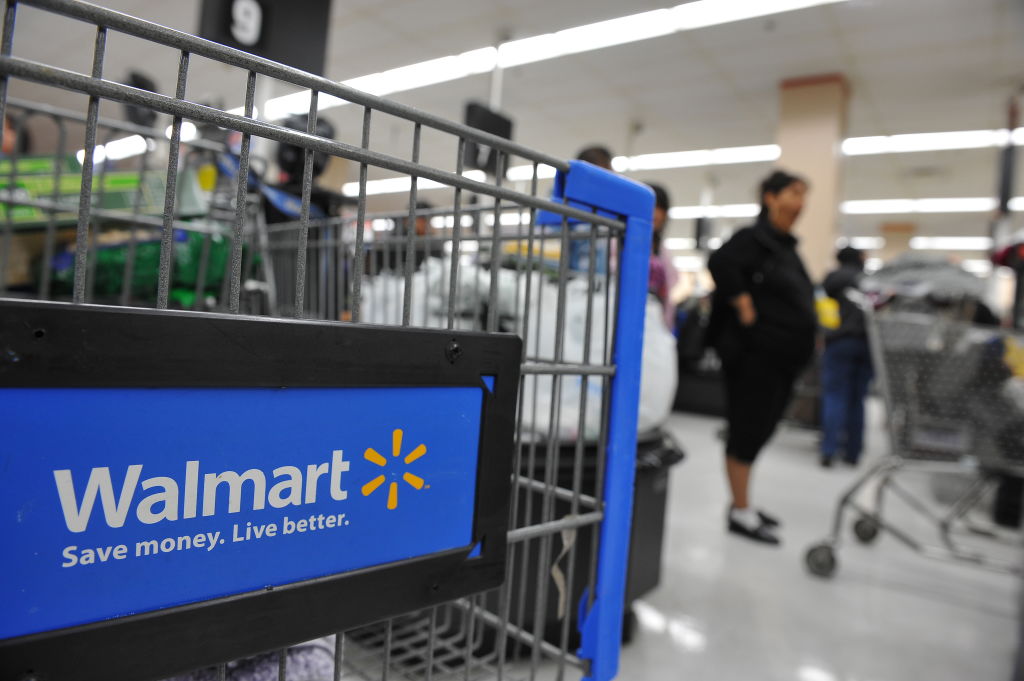 Shoppers wait in line to pay for their p