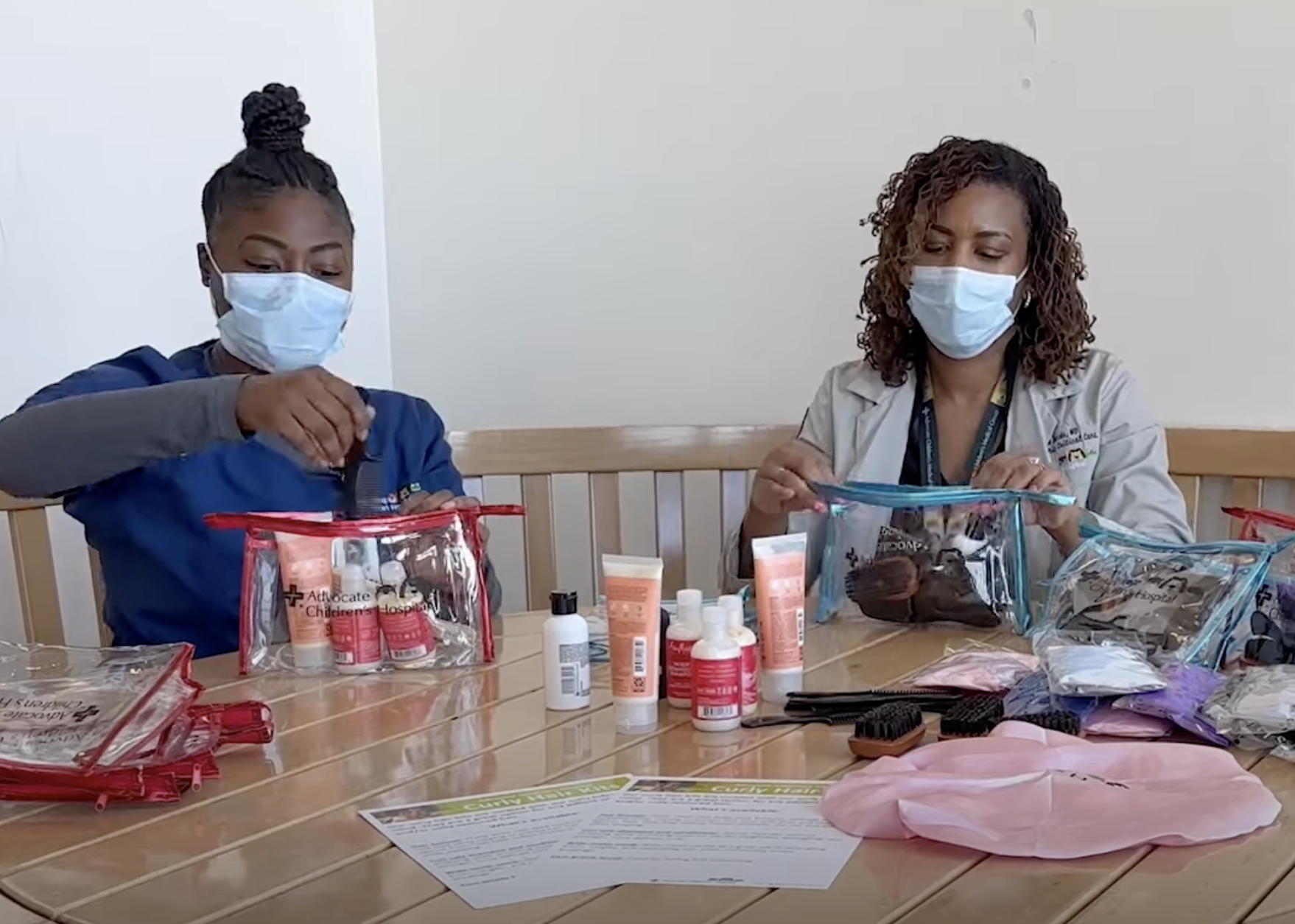 Dr. Nekaiya Jacobs stuffs hair kits with colleague