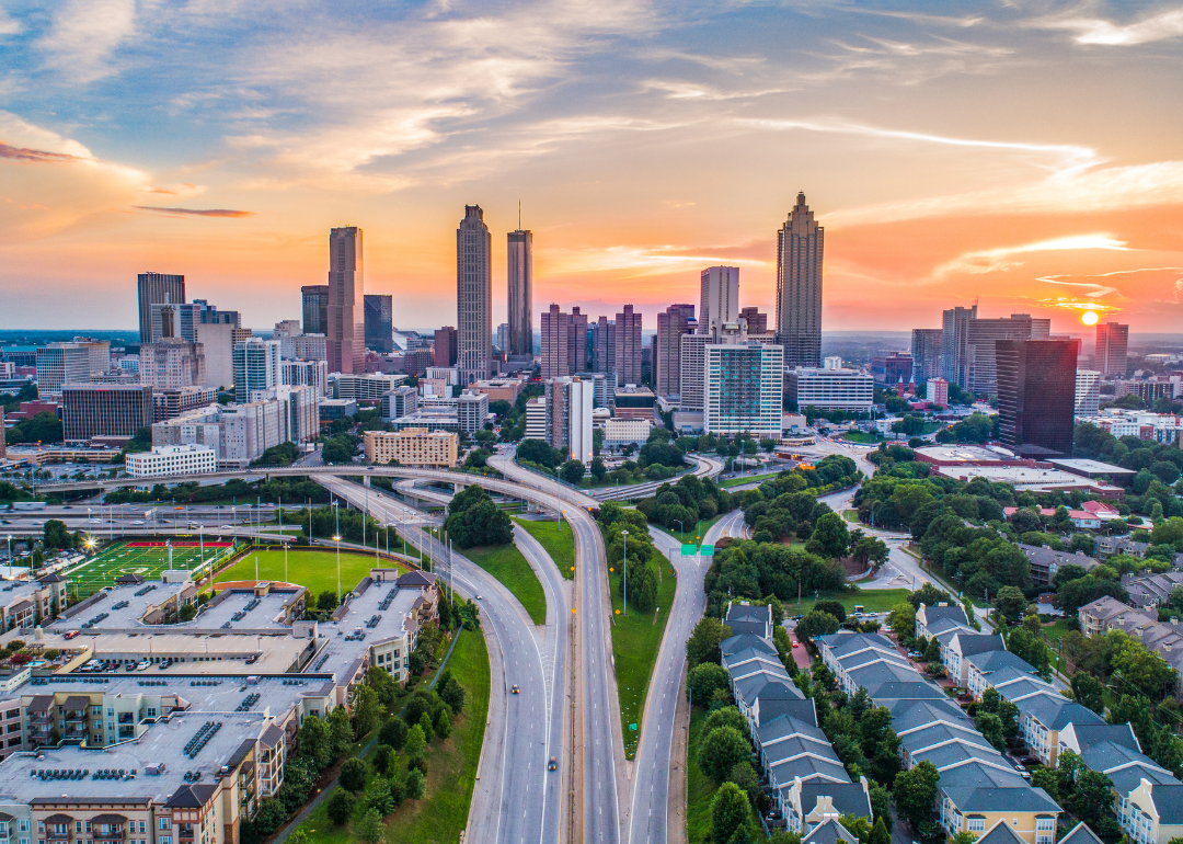 A highway leading into Atlanta with the city skyline in the background.