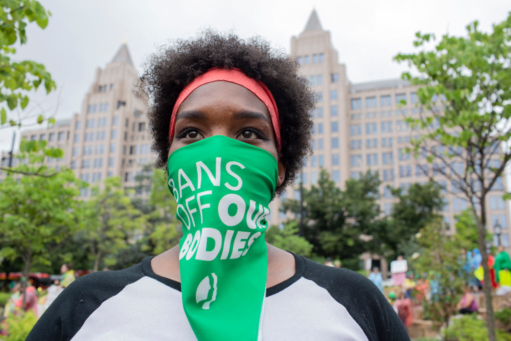 An abortion-rights activist listens to speakers before a...