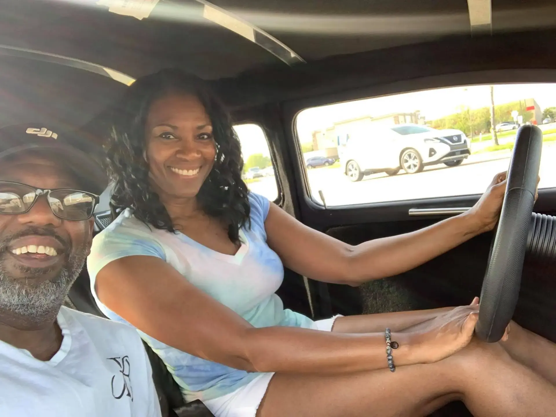 Bryan Ferguson takes a selfie with his wife, who is behind the wheel of a car