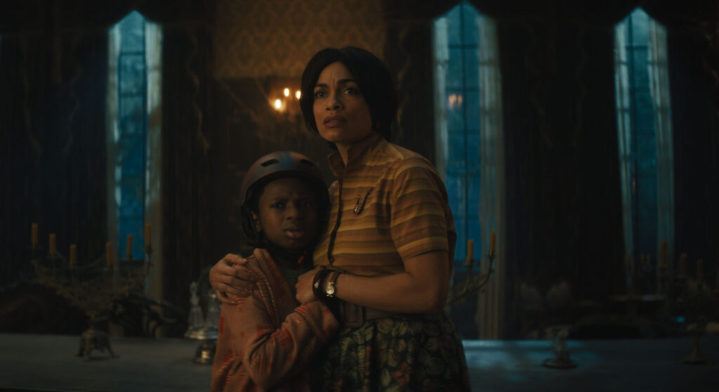 (L-R): Chase Dillon as Travis and Rosario Dawson as Gabbie in Disney's live-action HAUNTED MANSION. Photo courtesy of Disney. © 2023 Disney Enterprises, Inc. All Rights Reserved.