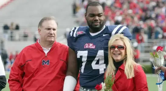 Michael Oher with Sean and Leigh Anne Tuohy (Matthew Sharpe-Getty Images)