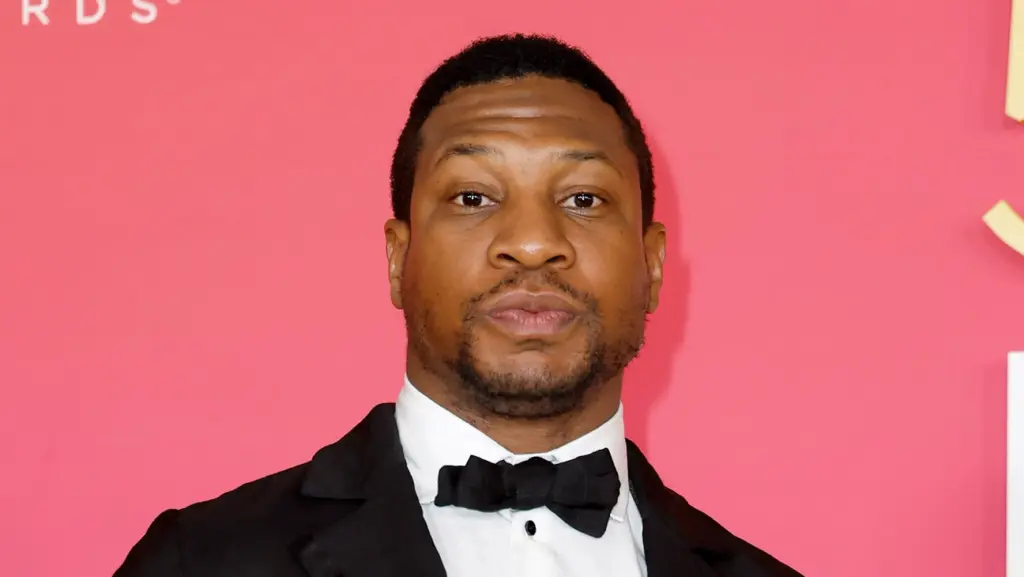 Jonathan Majors poses in front of a pink background - FRAZER HARRISON/GETTY IMAGES