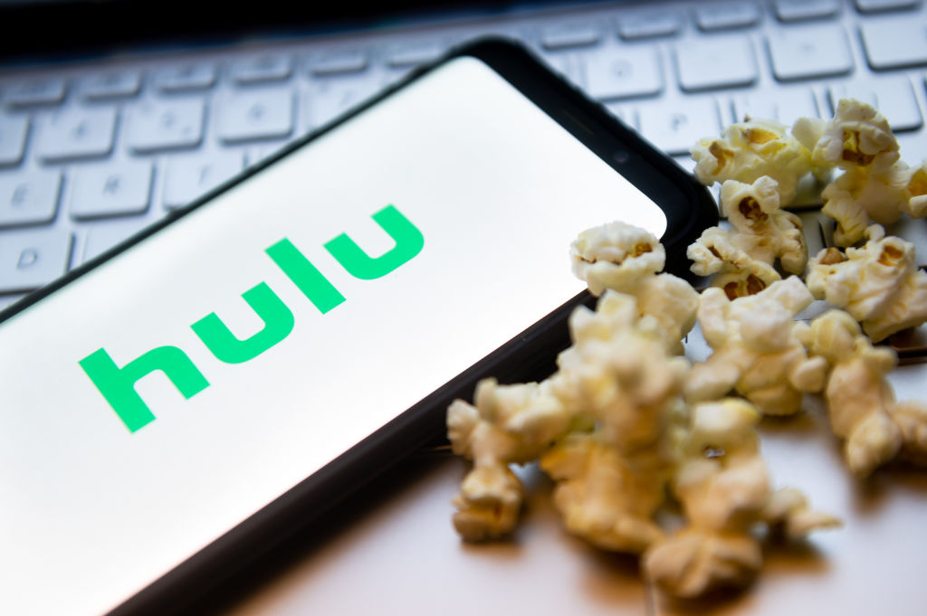 In this photo illustration a Hulu logo seen displayed on a...