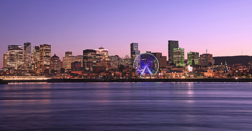 Montreal skyline at dusk with reflections in Saint Lawrence River, including newest skyscrapers