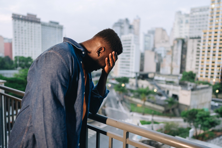 Worried mid adult man on footbridge outdoors