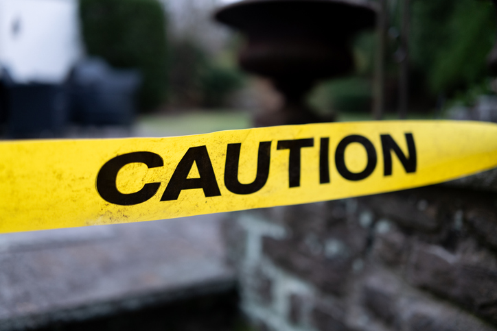 yellow plastic caution tape in front of slate steps