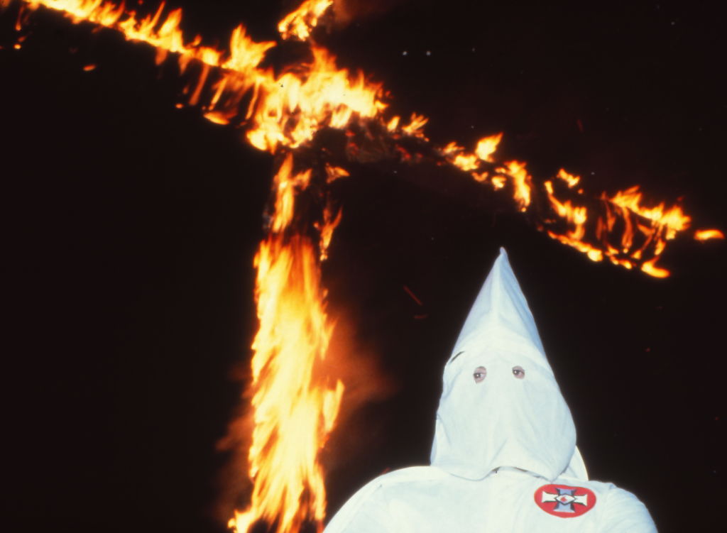 Ku Klux Klansman and a burning cross in Scotland, Connecticut in 1980