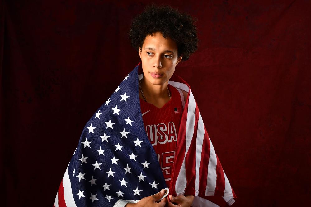 Brittney Griner and Wife Cherelle Welcome A Son // Britney Griner wrapped in flag (Barry Gossage-NBAE-Getty Images via CNN Newsource) 