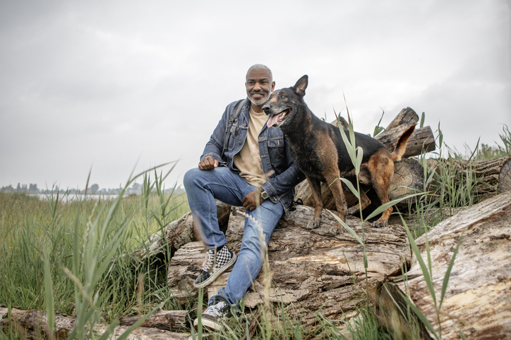 Handsome senior black man on staycation with his dog in the Netherlands