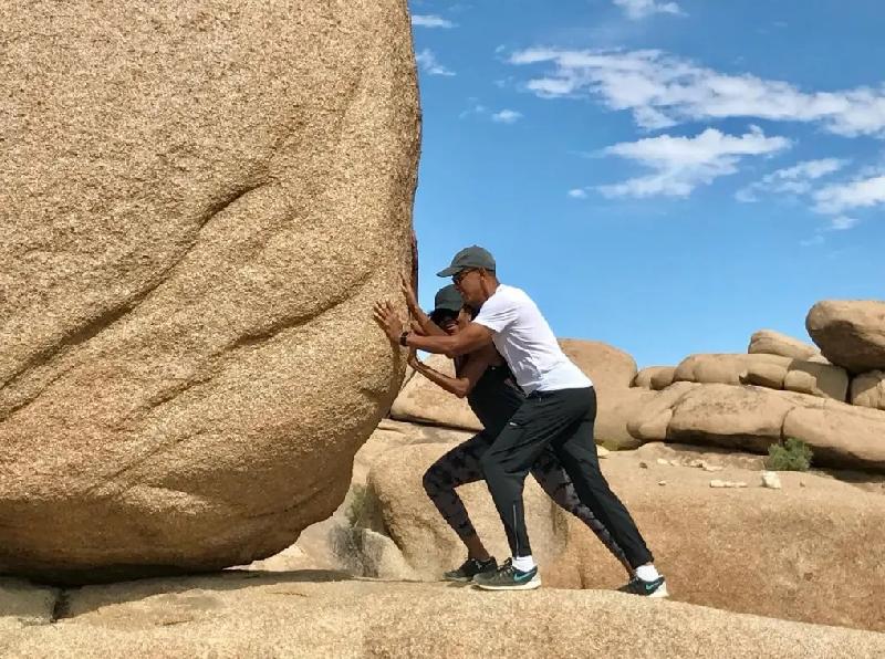 Michelle honors Barack's 63rd with heartfelt IG tribute // Barack and Michelle Obama pushing giant rock - via Instagram