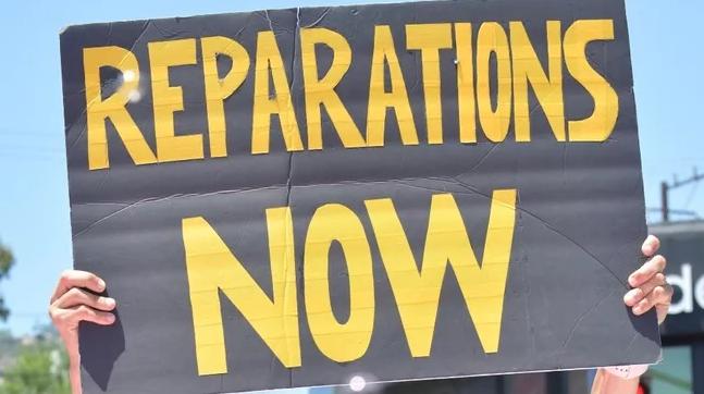 3 reparations bills by Sen. Bradford head to CA Assembly floor vote // Reparations Now (sign) - Getty