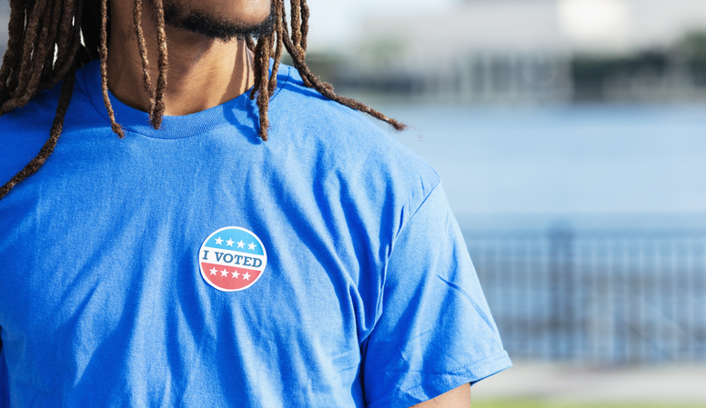 Young man with I Voted sticker on shirt