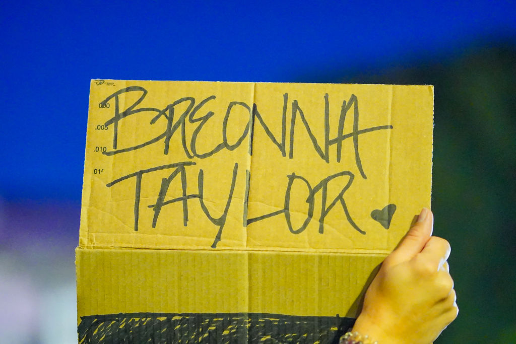 A protester holds a placard expressing her opinion during...