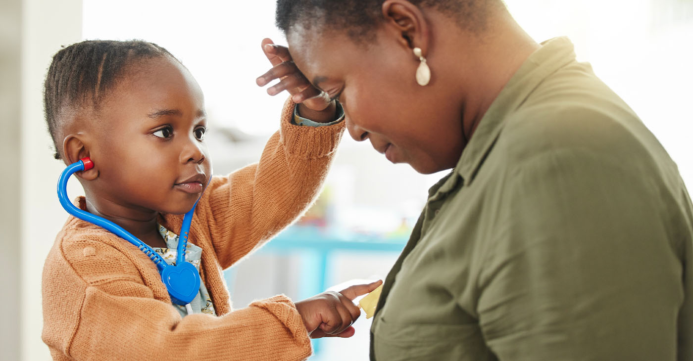 Little girl playing doctor while listening to her mother’s chest (Photo Credit by peoplelmages)